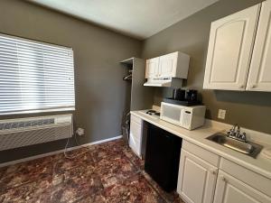 a small kitchen with a sink and a microwave at Bryce Canyon Resort in Bryce Canyon