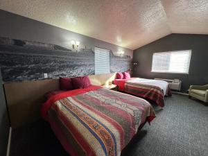 a bedroom with two beds and a wall with a picture at Bryce Canyon Resort in Bryce Canyon +82 photos