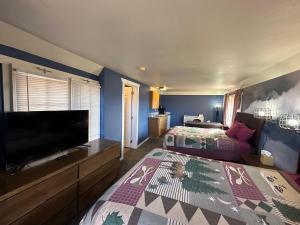 a bedroom with two beds and a flat screen tv at Bryce Canyon Resort in Bryce Canyon
