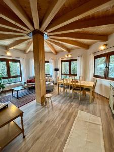 a living room with wooden ceilings and a table and chairs at Appartments Prinz - Gerlitze in Tobitsch