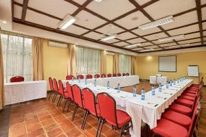 a conference room with a long table and red chairs at Sagana Getaway Resort in Maranjua +97 photos