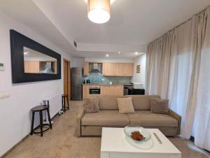 a living room with a couch and a table at Relax en Lloret con Gym y Piscina by Host&Joy in Lloret de Mar