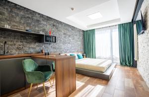 a bedroom with a bed and a desk with a desk at New Gudauri Twins Horizon in Gudauri