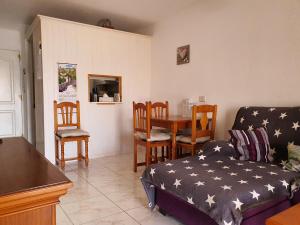 a living room with a couch and a table and chairs at Casa Kiara in Costa Calma