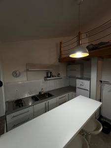 a kitchen with a white counter top and a sink at Tesla Apartman in Risan +5 photos