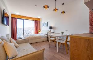 a living room with a bed and a dining room at New Gudauri Twins Horizon in Gudauri +22 photos