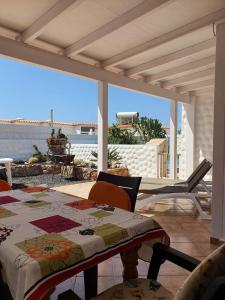 a table and chairs on a patio with a view of the ocean at Casa Kiara in Costa Calma