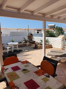 a patio with a table and chairs on a deck at Casa Kiara in Costa Calma