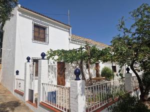 a white house with a white fence at Stunning views, 3 bed, private pool, olive grove in Iznájar