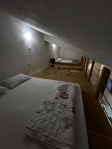 a bedroom with a large white bed in a room at Tesla Apartman in Risan