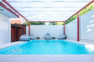 a swimming pool with a pergola and a swimming poolvisor at Holiday Home Ajna in Bihać