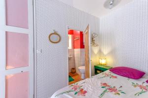 a bedroom with a bed and a bathroom at Cool charming appartment in historic forcalquier in Forcalquier