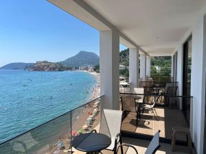 a balcony with a view of a beach and the ocean at Hotel Sutomore in Sutomore +32 photos