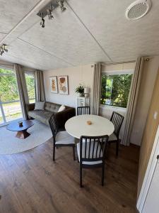 a living room with a table and chairs and a couch at Beach Chalet Sunny Dunes in Petten