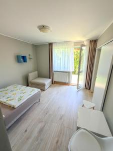 a small room with a bed and a window at Rafa in Rowy +29 photos