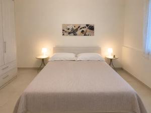 a bedroom with a large bed with two side tables at Borgo San Michele Bed & Breakfast in Calvisano