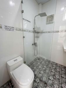 a white bathroom with a shower and a toilet at Bungalow Gió Hát in Phú Quốc +18 photos