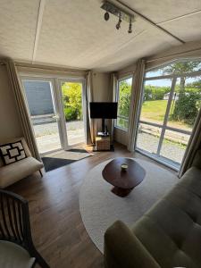 a living room with a couch and a table at Beach Chalet Sunny Dunes in Petten
