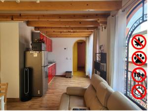 a living room with a couch and a stained glass window at Villa Alfonsina in Mexico City