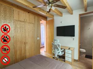 a bedroom with a bed with a ceiling fan and a desk at Villa Alfonsina in Mexico City
