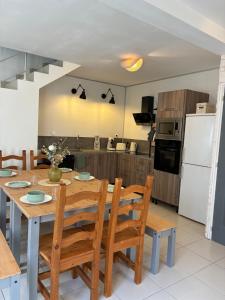 a kitchen and dining room with a table and chairs at Le 36 du prieuré in Arbois