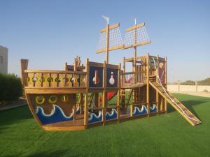 a playground with a slide on a grass field at White Bay Ras Sedr وايت باي راس سدر in Ras Sedr
