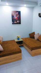 two beds in a room with a painting on the wall at The Comfortable palace in Hurghada