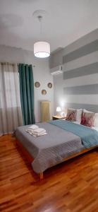 a bedroom with a large bed with green curtains at Anna's Cozy Place in Sparta