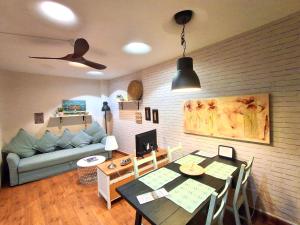 a living room with a table and a couch at Logrocity Corazon de Logroño PARKING PRIVADO GRATIS in Logroño