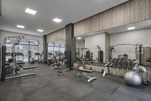 a gym with lots of exercise equipment in a room at Stunning Studio Pool View CFC Casablanca in Casablanca