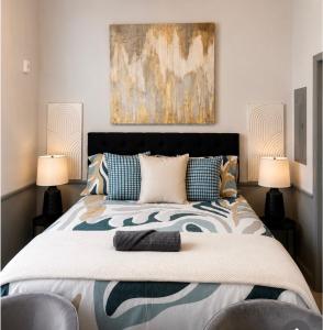 a bedroom with a large bed with two lamps at Stylish Birmingham Loft + Rooftop Lounge in Birmingham