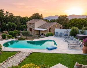 a backyard with a swimming pool and a house at B&B Arghjola in Porto-Vecchio