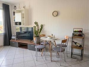 a living room with a table and a tv at Apartman"Petra" in Krk +10 photos