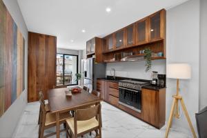 a kitchen with wooden cabinets and a wooden table with a dining room at Unit Aguacates Romantic Zone in Puerto Vallarta