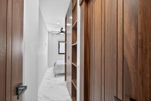 a hallway with a closet with wooden doors at Unit Aguacates Romantic Zone in Puerto Vallarta +27 photos