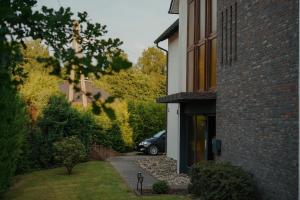 a car parked outside of a house with a driveway at Emotion Apartments- Erlebnis Apartment mit privater Sauna und Whirlpool in Vlotho