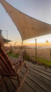 a wooden chair sitting on a table next to a beach at The whale in Guaquen