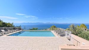 a swimming pool with a view of the water at Theologos Ridge in Theologos