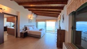 a bedroom with a bed and a view of the ocean at Theologos Ridge in Theologos +76 photos