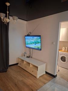 a living room with a television on a wall at Łokietka in Inowrocław