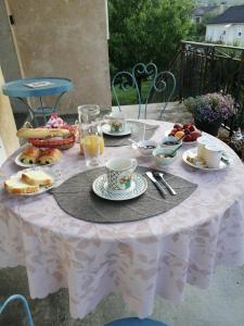a white table with food and drinks on it at Pause Périgord in Saint-Cyprien