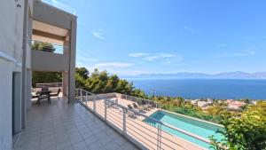 a balcony of a house with a view of the water at Theologos Ridge in Theologos