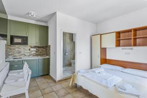 a bedroom with a bed and a kitchen at Utković Beachfront Apartments in Vrsi +80 photos