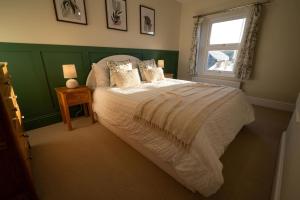 a bedroom with a large bed and a window at The Nook in Claypits