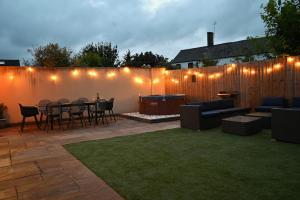 a patio with a table and chairs and a fence at The Nook in Claypits +52 photos