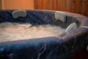 a blue tub filled with water in at The Nook in Claypits