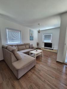 a living room with a couch and a tv at Kuća za odmor Postonjski in Maslenica