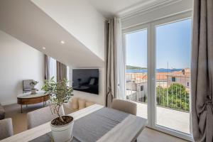 a living room with a table and a large window at Villa Mare's in Primošten