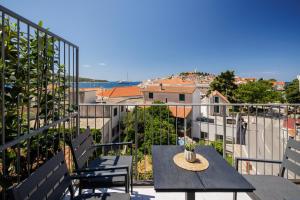 a patio with a table and chairs on a balcony at Villa Mare's in Primošten