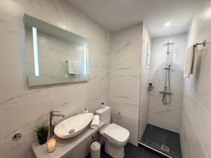 a white bathroom with a sink and a toilet at Alexandros Luxury Apartment in Glossa +30 photos